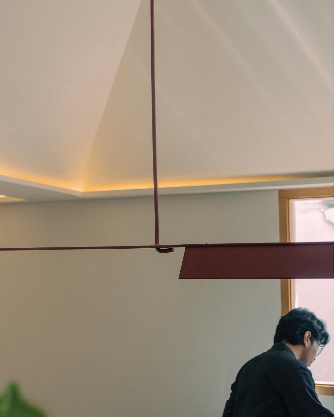 Maroon ceiling fixture against cream interior